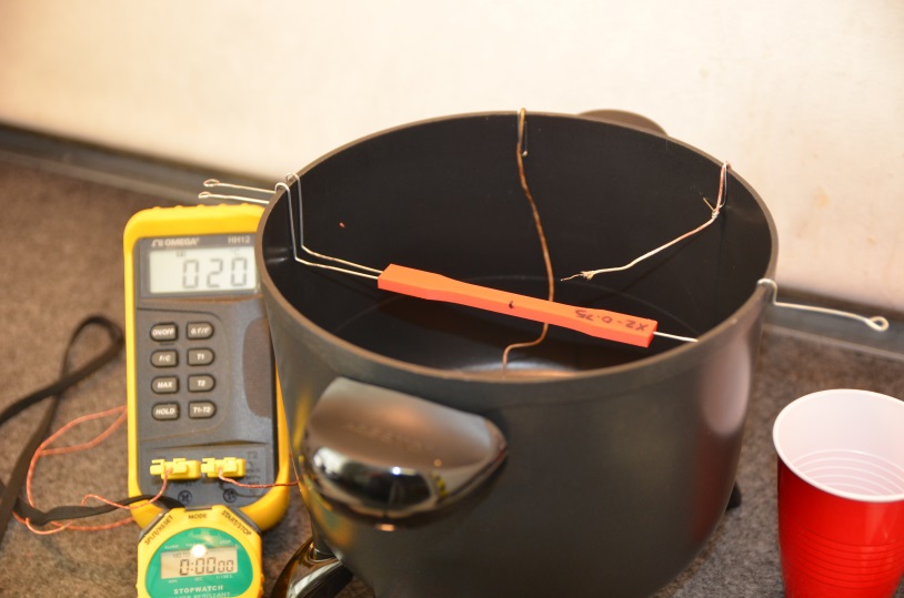 Plastic tensile samples suspended over acetone bath