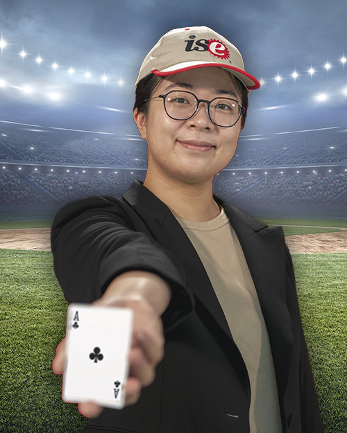 April Yu holding a ace card in front of a stadium.