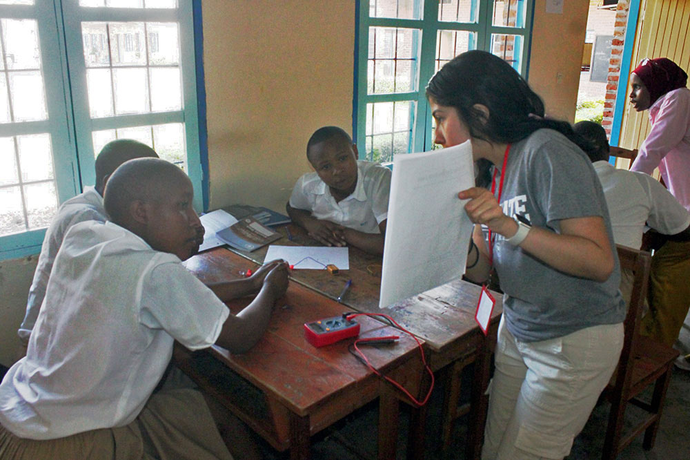 ISE student Daniela Santibanez working with several students 